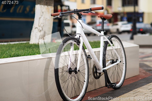 Image of white fixed-gear bicycle on street