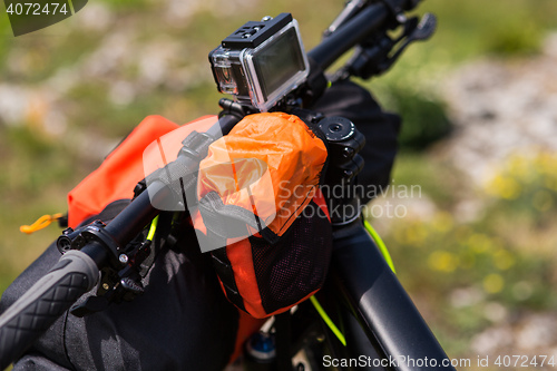 Image of Bicycle with orange bags for travel