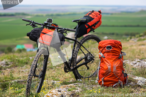 Image of Bicycle with orange bags for travel