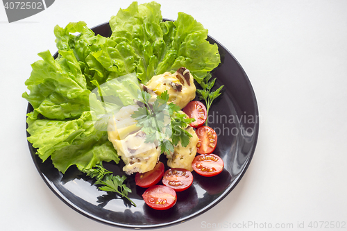 Image of Potatoes stuffed with bacon and small tomatoes