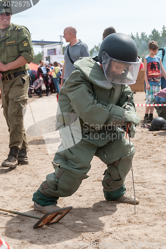 Image of Visitors of show try on the sapper suit