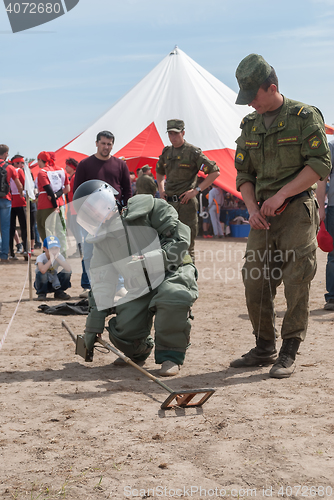 Image of Visitors of show try on the sapper suit