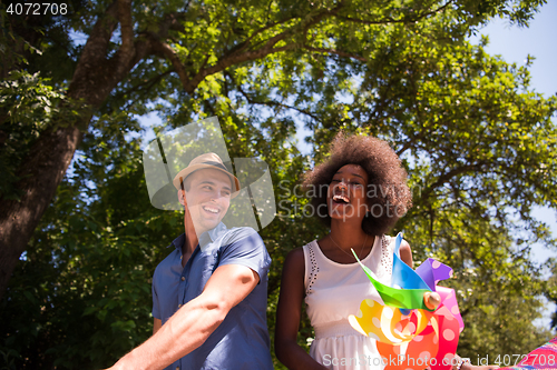 Image of Young multiethnic couple having a bike ride in nature