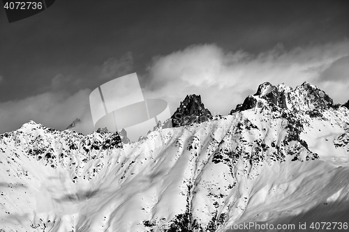 Image of Black and white snow avalanches mountainside in clouds