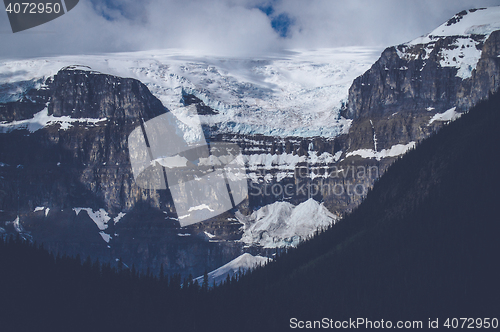 Image of Mountains with snow in cloudy weather