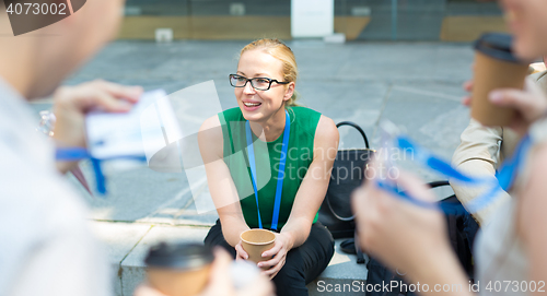 Image of Cheerful colleagues meeting for coffee break.