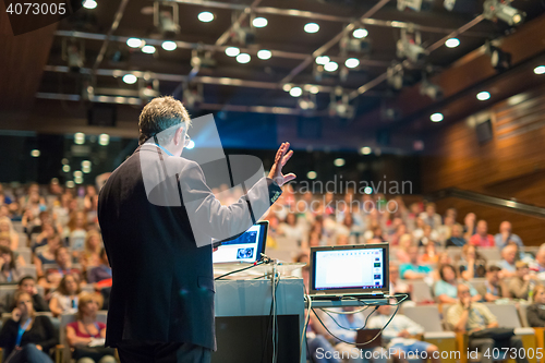 Image of Public speaker giving talk at Business Event.