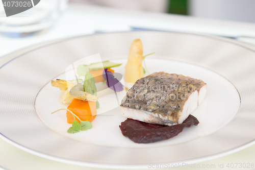 Image of minimalistic dish fish with vegetables