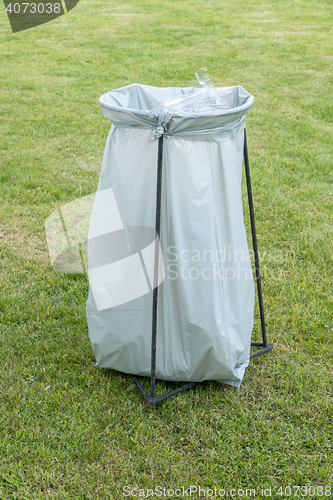 Image of trashcan - a plastic garbage bag on an iron frame