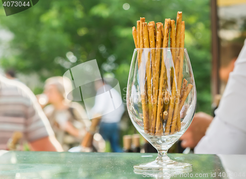 Image of bread sticks with sesame in a glass