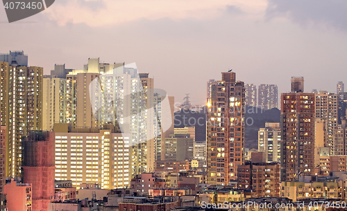 Image of urban city at sunset with all lights lit up 