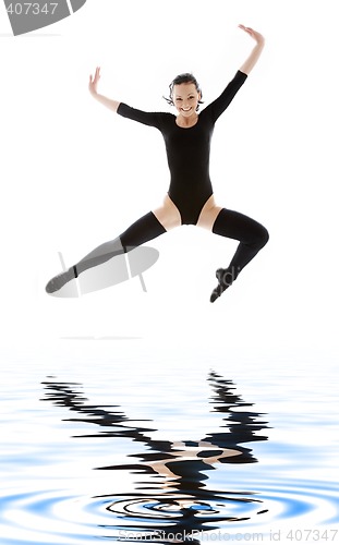 Image of girl in black leotard jumping over water