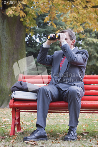 Image of Businessman searching with binoculars