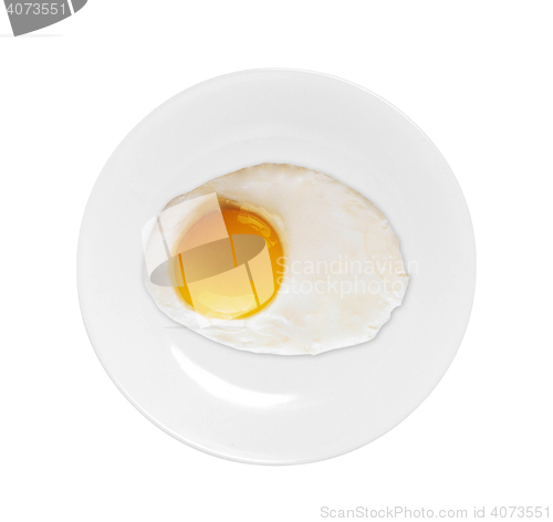 Image of Top view of white dish with fried egg