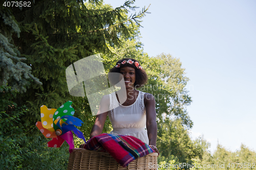 Image of pretty young african american woman riding a bike in forest