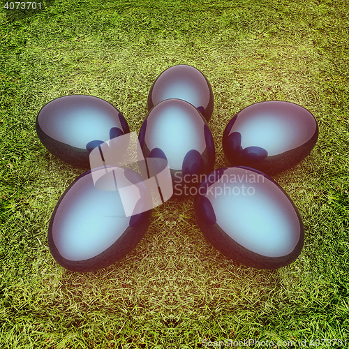 Image of Metallic blue Easter eggs as a flower on a green grass. 3D illus