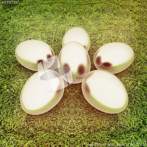 Image of Metall Easter eggs as a flower on a green grass. 3D illustration