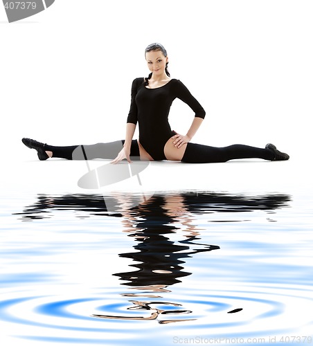 Image of fitness instructor in black leotard on white sand