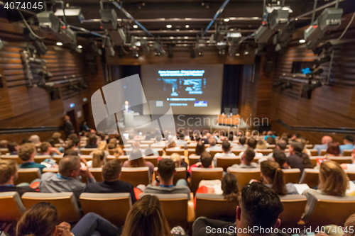 Image of Business speaker giving a talk in conference hall.