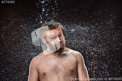 Image of The water splash on male face