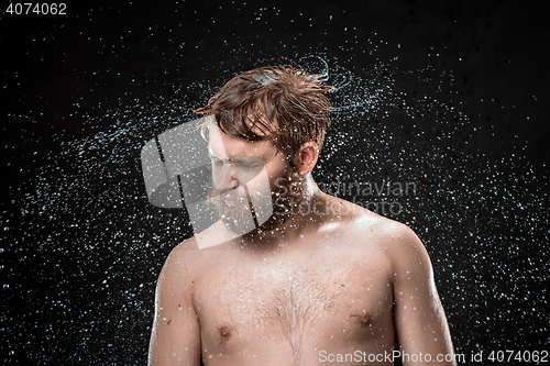 Image of The water splash on male face