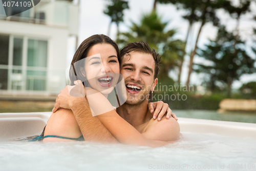 Image of Young couple in a jacuzzi