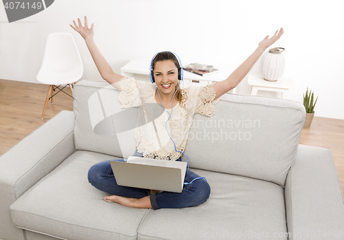 Image of Listen music on her laptop