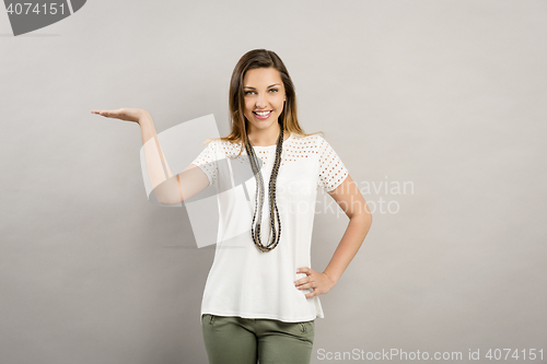 Image of Lovely woman showing something
