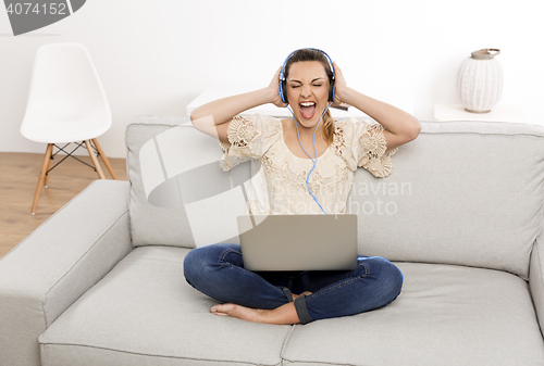 Image of Listen music on her laptop