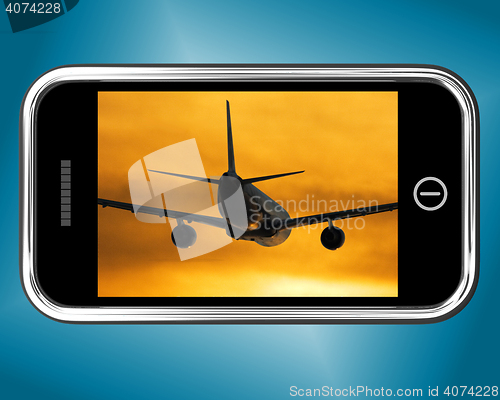 Image of Airplane Flying Towards The Sunset On Mobile Phone