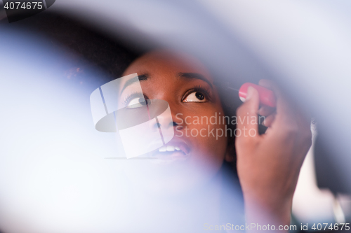 Image of a young African-American woman makeup in the car