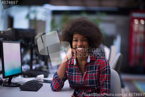 Image of portrait of a young African American woman in modern office