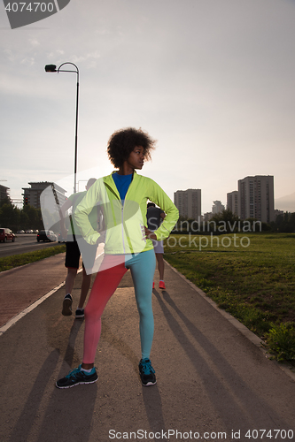 Image of Portrait of sporty young african american woman running outdoors