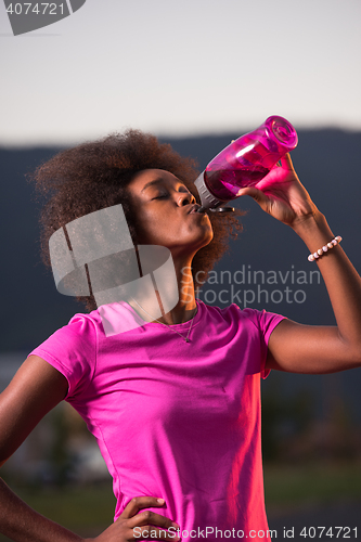 Image of Portrait of a young african american woman running outdoors