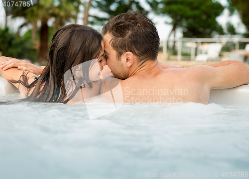 Image of Young couple in a jacuzzi