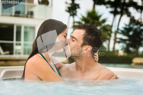 Image of Young couple in a jacuzzi