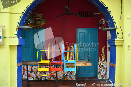 Image of Colorful chairs on a wooden table