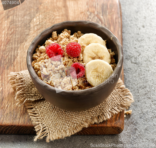 Image of bowl of granola with banana and raspberries