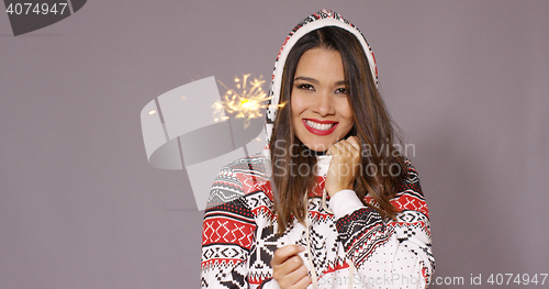 Image of Pretty woman celebrating Christmas with fireworks