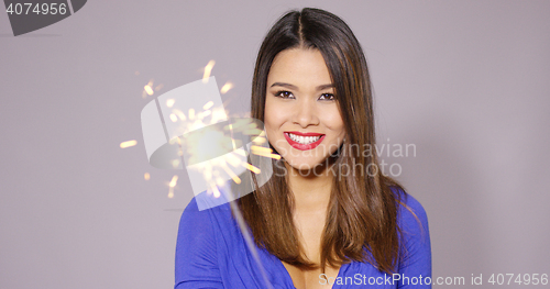 Image of Happy young woman celebrating at a party