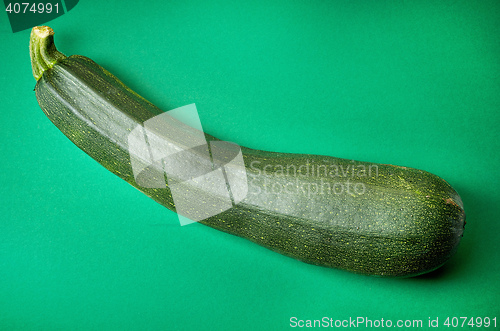 Image of fresh zucchini on green background