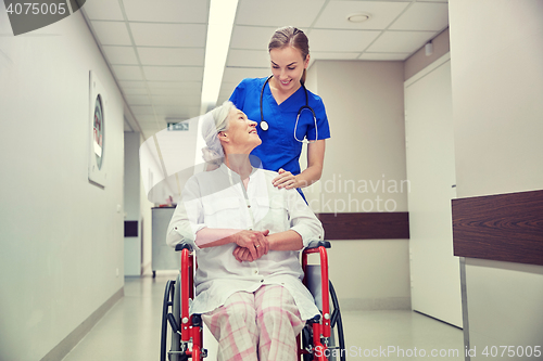 Image of nurse with senior woman in wheelchair at hospital