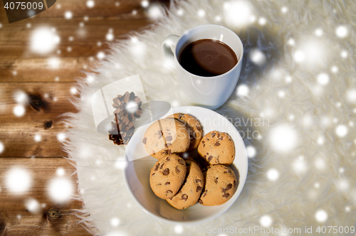 Image of cups of hot chocolate with cookies on fur rug