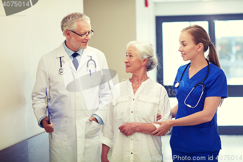 Image of medics and senior patient woman at hospital