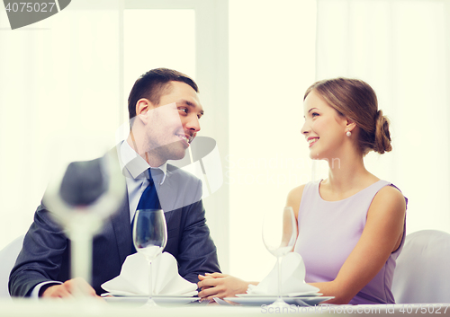 Image of smiling couple looking at each other at restaurant