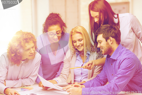 Image of smiling team with color samples at office