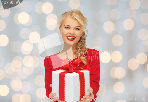 Image of happy smiling woman in red dress with gift box