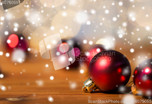 Image of close up of red christmas balls on wood