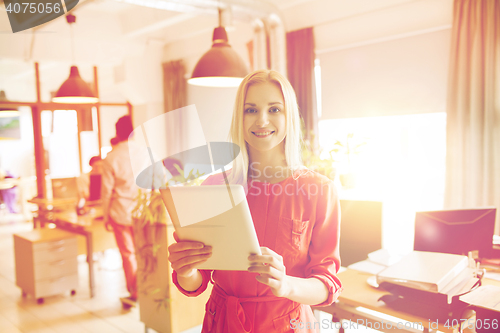 Image of happy creative female office worker with tablet pc