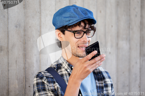 Image of man recording voice or calling on smartphone